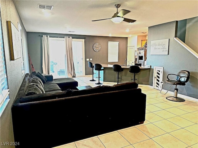 living room with ceiling fan and light tile patterned floors