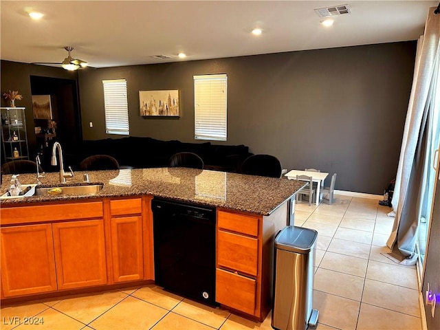 kitchen with ceiling fan, black dishwasher, light tile patterned flooring, stone countertops, and sink