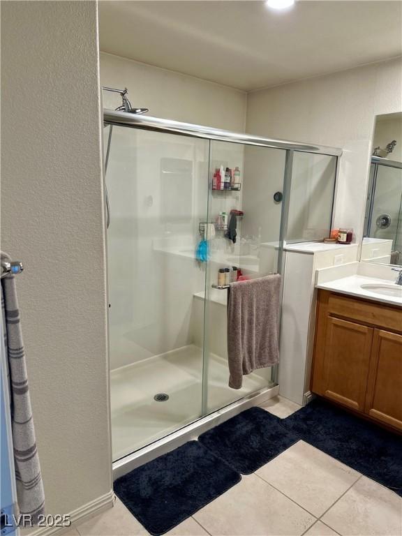 bathroom featuring vanity, tile patterned floors, and an enclosed shower