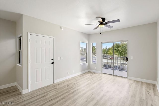 unfurnished room featuring light wood-type flooring, ceiling fan, and baseboards