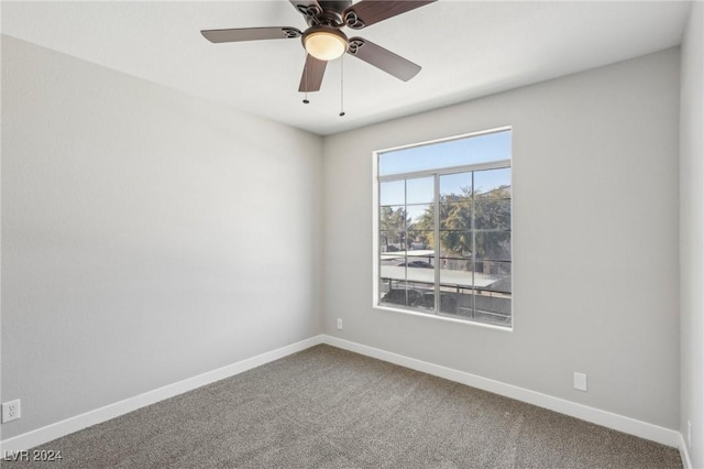 unfurnished room featuring carpet floors, baseboards, and a ceiling fan