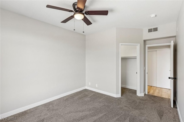 unfurnished bedroom with carpet floors, a ceiling fan, visible vents, baseboards, and a closet