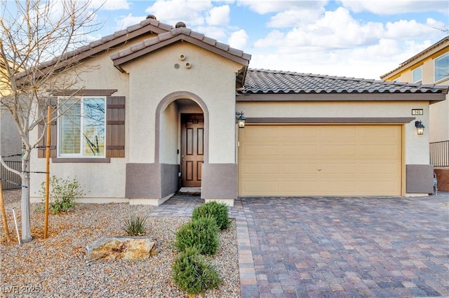 mediterranean / spanish-style house with a garage