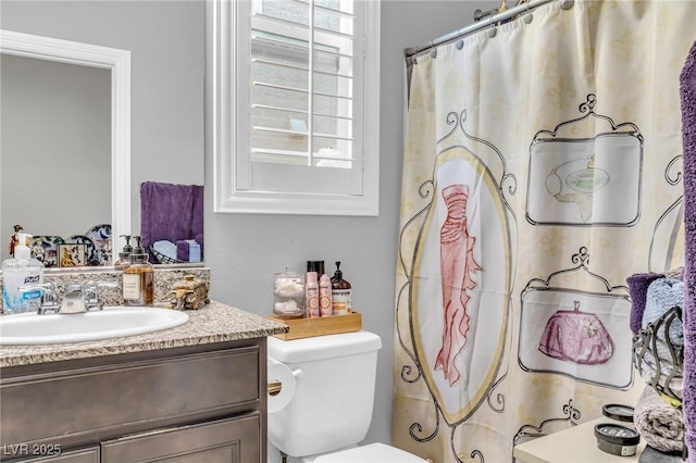 bathroom featuring vanity and toilet