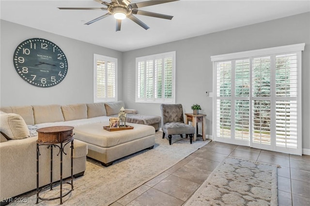 living room with ceiling fan, plenty of natural light, and tile patterned flooring