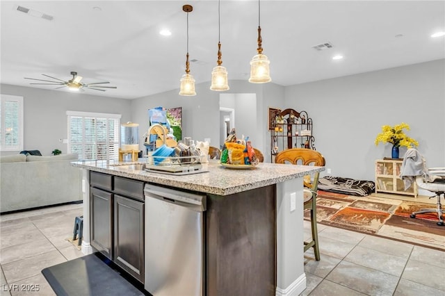 kitchen featuring stainless steel dishwasher, ceiling fan, an island with sink, decorative light fixtures, and dark brown cabinetry