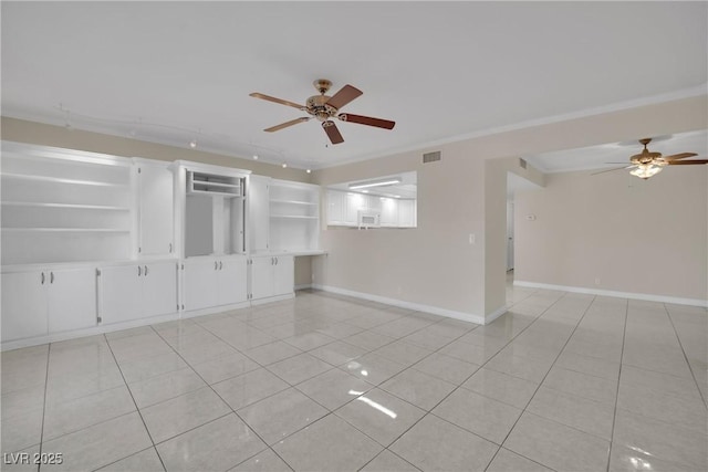 unfurnished room featuring ceiling fan, ornamental molding, built in features, and light tile patterned floors