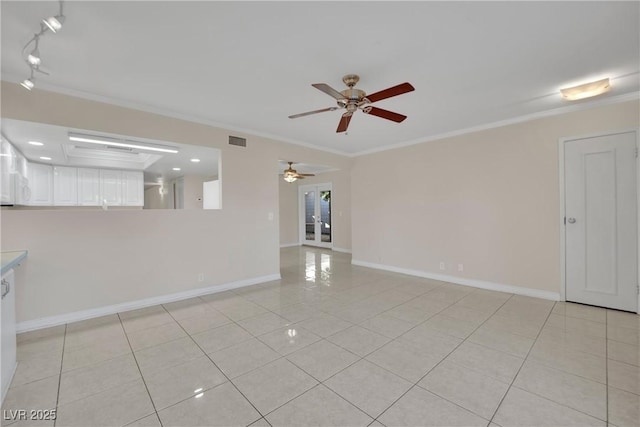 spare room featuring crown molding, ceiling fan, rail lighting, and light tile patterned flooring