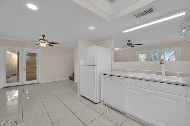 kitchen featuring sink, white appliances, light tile patterned floors, white cabinetry, and french doors