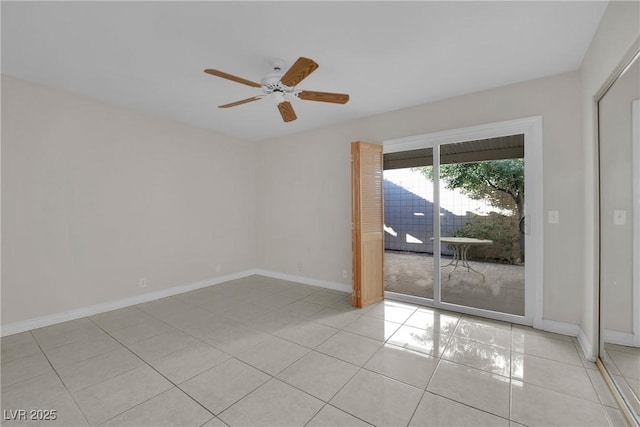 tiled empty room featuring ceiling fan