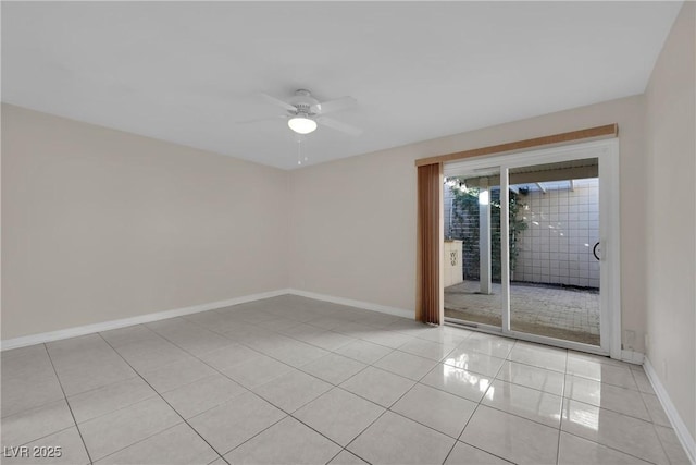 spare room with ceiling fan and light tile patterned flooring