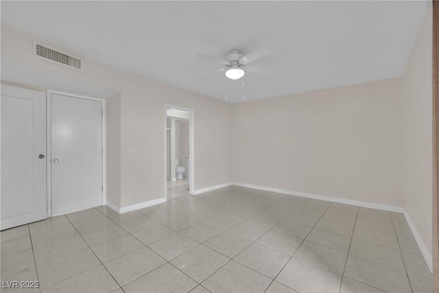 tiled empty room with ceiling fan