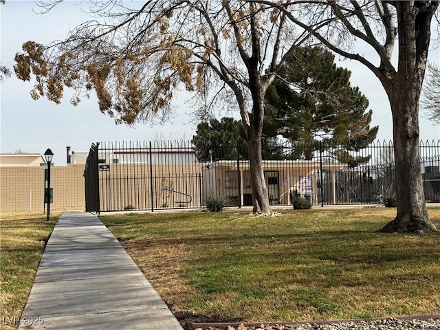 view of gate with a yard