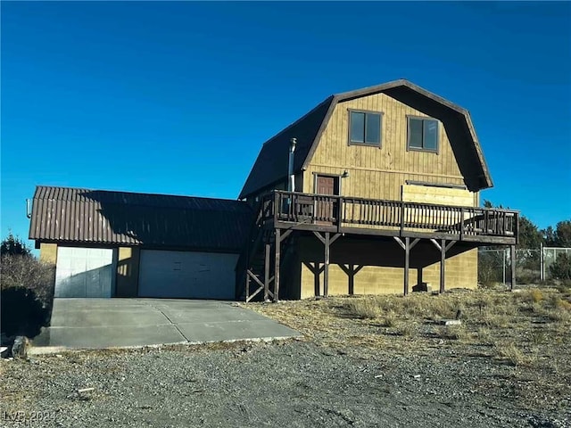 view of front of house featuring a garage and a deck