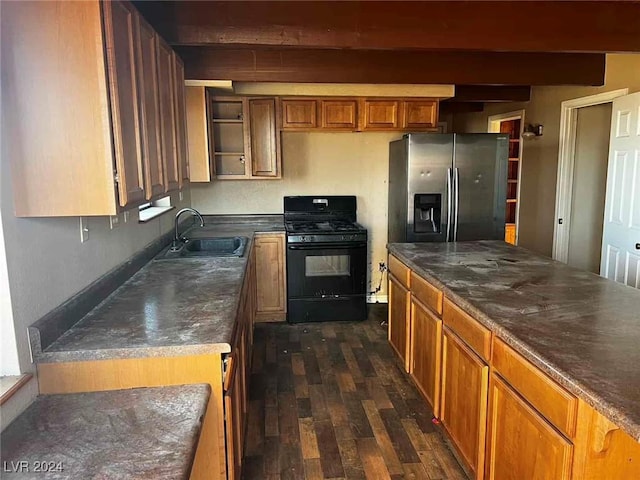 kitchen with black gas range, dark wood-type flooring, sink, stainless steel fridge, and beam ceiling