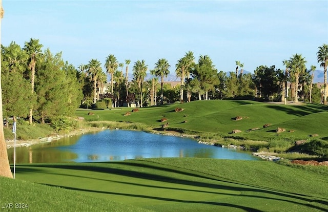 view of community with a yard and a water view