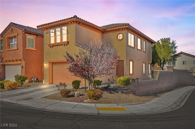 mediterranean / spanish-style home featuring a garage