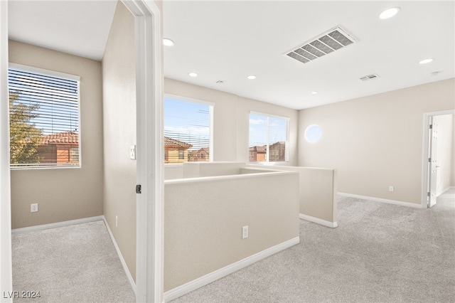 hallway with light colored carpet