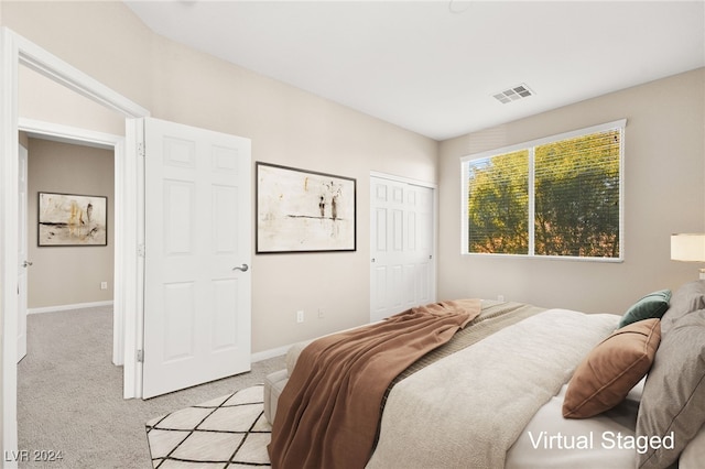 bedroom with light colored carpet and a closet