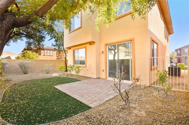 rear view of property featuring a patio area