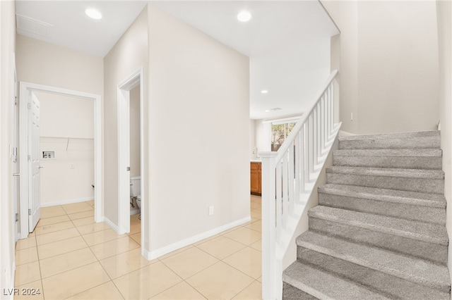 stairs with tile patterned floors