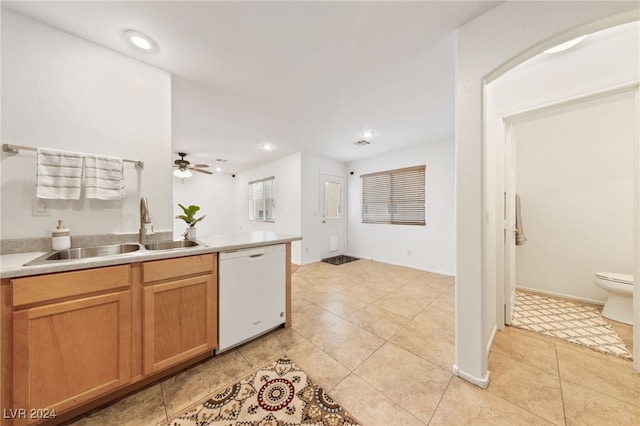 kitchen featuring dishwasher, ceiling fan, light tile patterned flooring, and sink