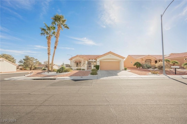 mediterranean / spanish-style home with a garage