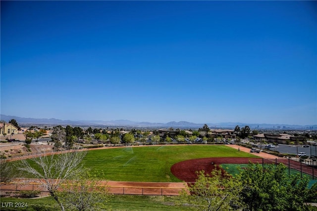 view of property's community with a mountain view and a yard