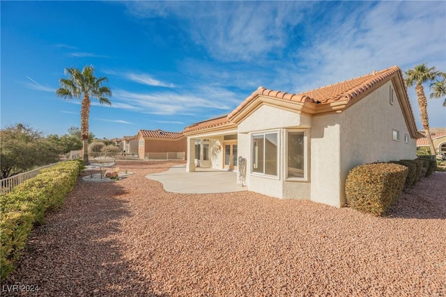 back of property featuring a patio