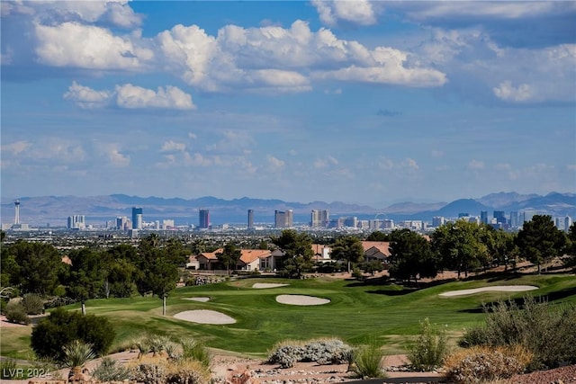 surrounding community with a lawn and a mountain view