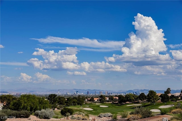 surrounding community featuring a lawn and a mountain view