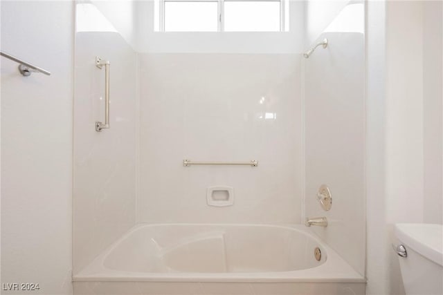 bathroom with bathtub / shower combination and toilet