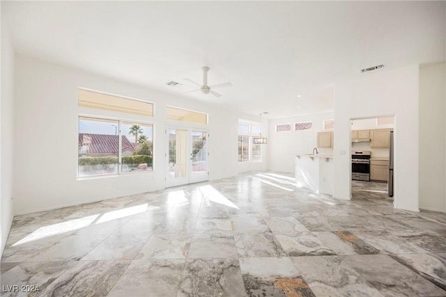 unfurnished room with french doors and ceiling fan