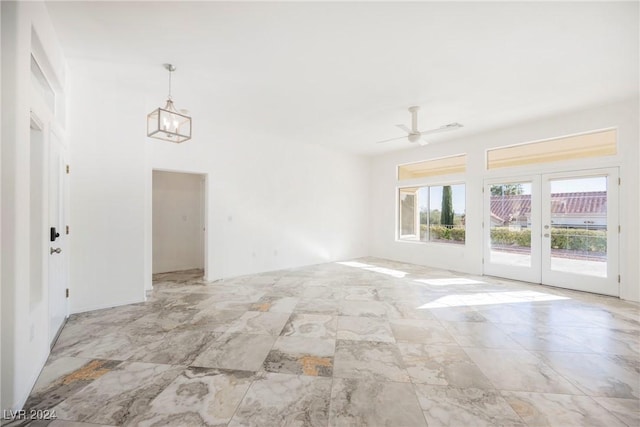 empty room with ceiling fan and french doors