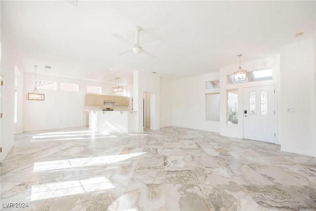 unfurnished living room with ceiling fan