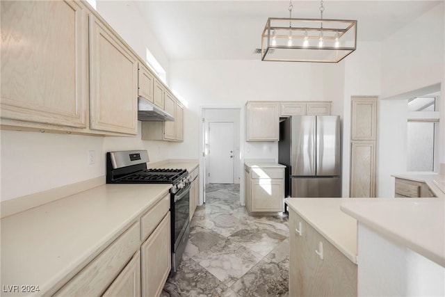 kitchen featuring a towering ceiling, pendant lighting, light brown cabinets, and stainless steel appliances