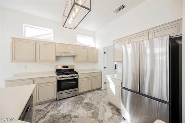 kitchen featuring a towering ceiling and stainless steel appliances