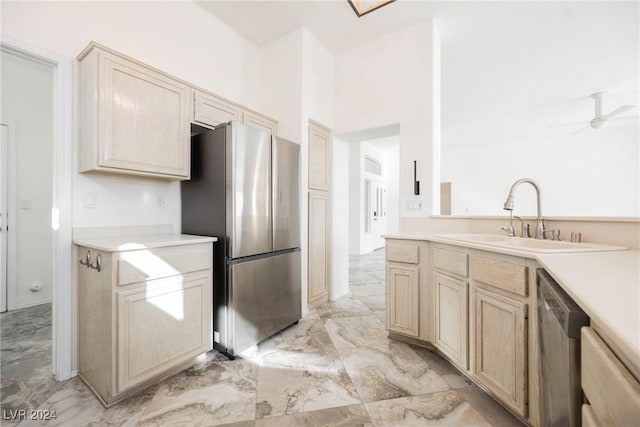 kitchen featuring ceiling fan, sink, light brown cabinets, and appliances with stainless steel finishes