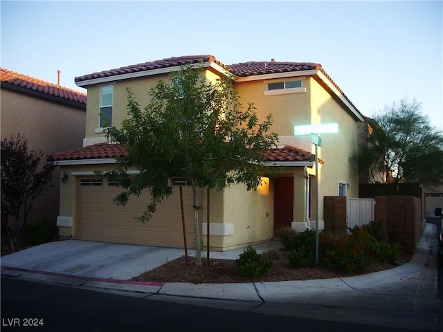 mediterranean / spanish-style home featuring a garage