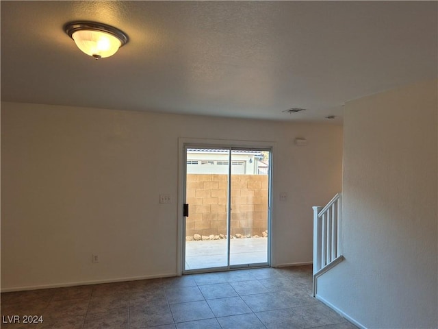 spare room with tile patterned flooring