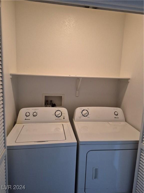 clothes washing area with washer and clothes dryer