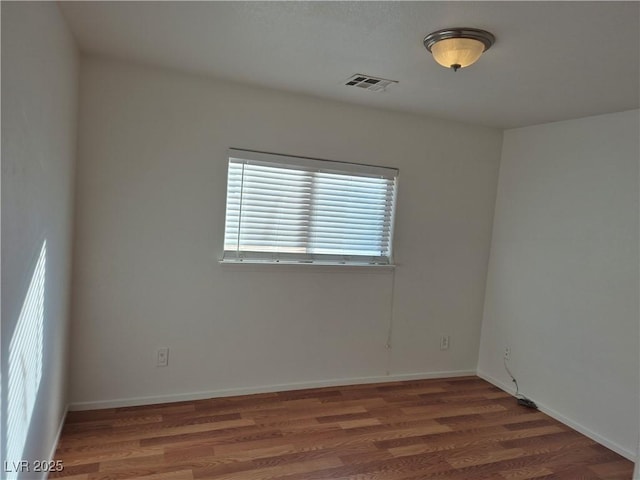 spare room with dark wood-type flooring