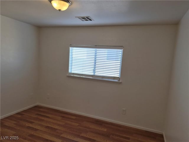 empty room with dark hardwood / wood-style flooring