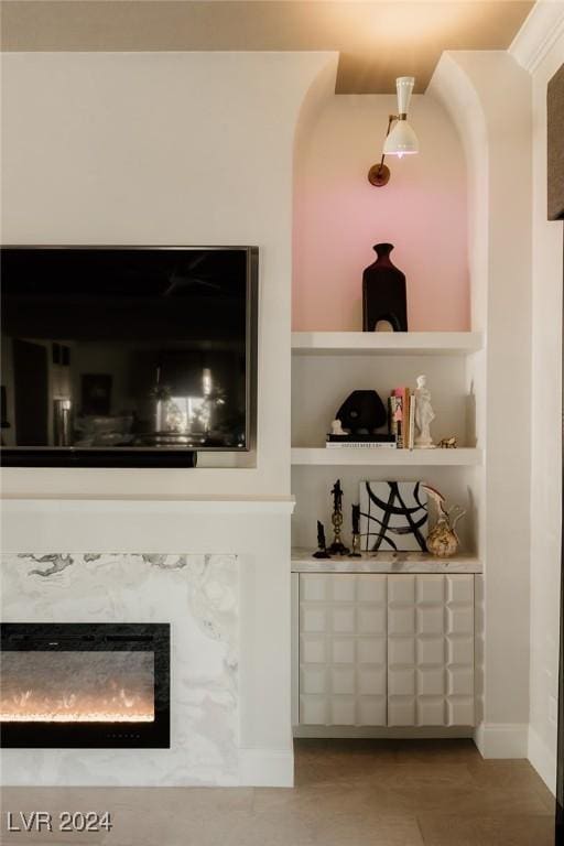 bar featuring built in shelves and a fireplace