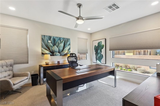 carpeted office space with ceiling fan