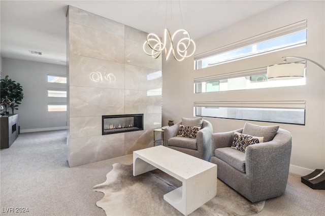 living room featuring a tiled fireplace and light carpet