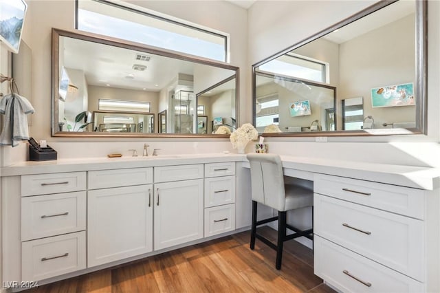 bathroom with hardwood / wood-style floors, plenty of natural light, and vanity