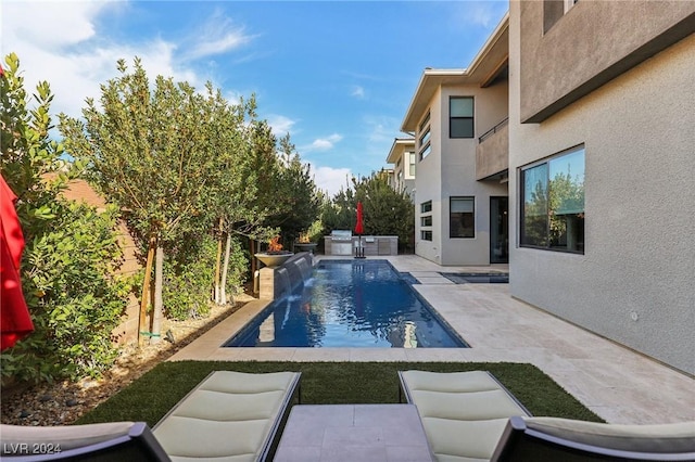 view of swimming pool featuring pool water feature and a patio