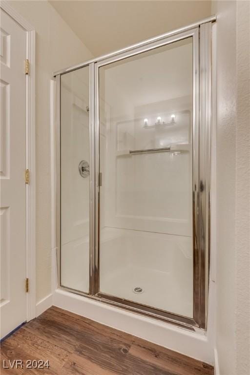 bathroom with hardwood / wood-style floors and walk in shower