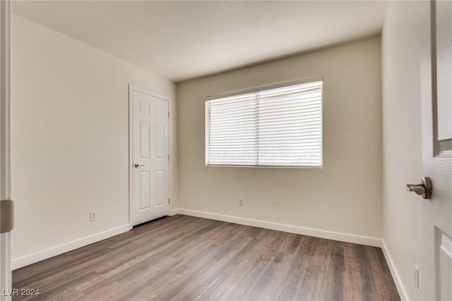 unfurnished room with wood-type flooring